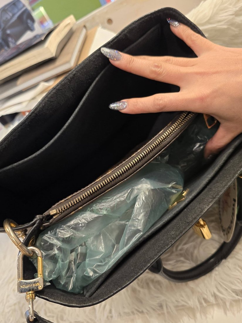 The interior lining of a bag, opened to show the seams and pockets