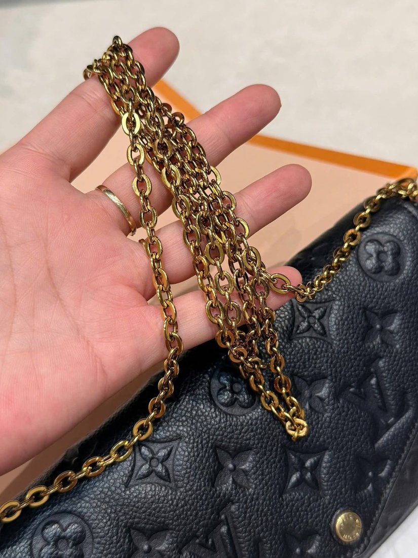 Louis Vuitton Felicie pochette in black Monogram Empreinte leather with a gold chain