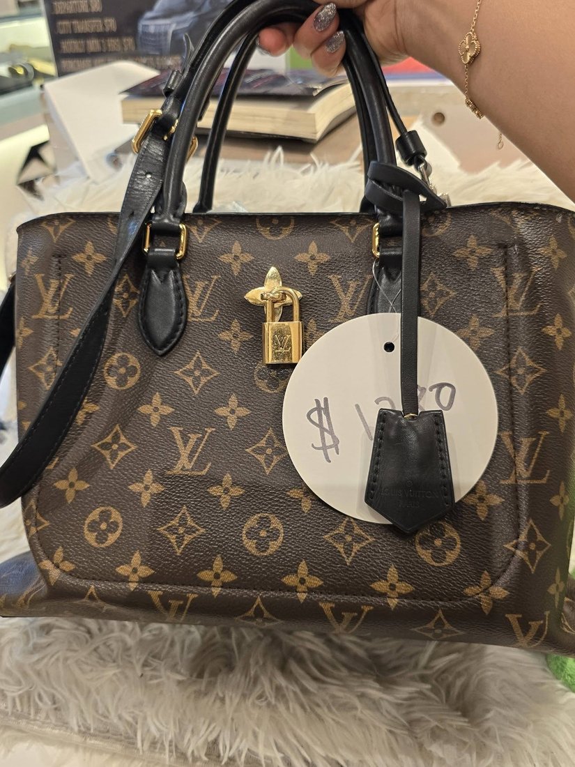 Louis Vuitton Monogram canvas tote with black leather handles and a padlock